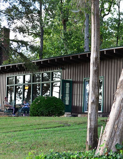 Exterior front view of Guntersville Getaway waterfront vacation home nestled among mature trees on Lake Guntersville