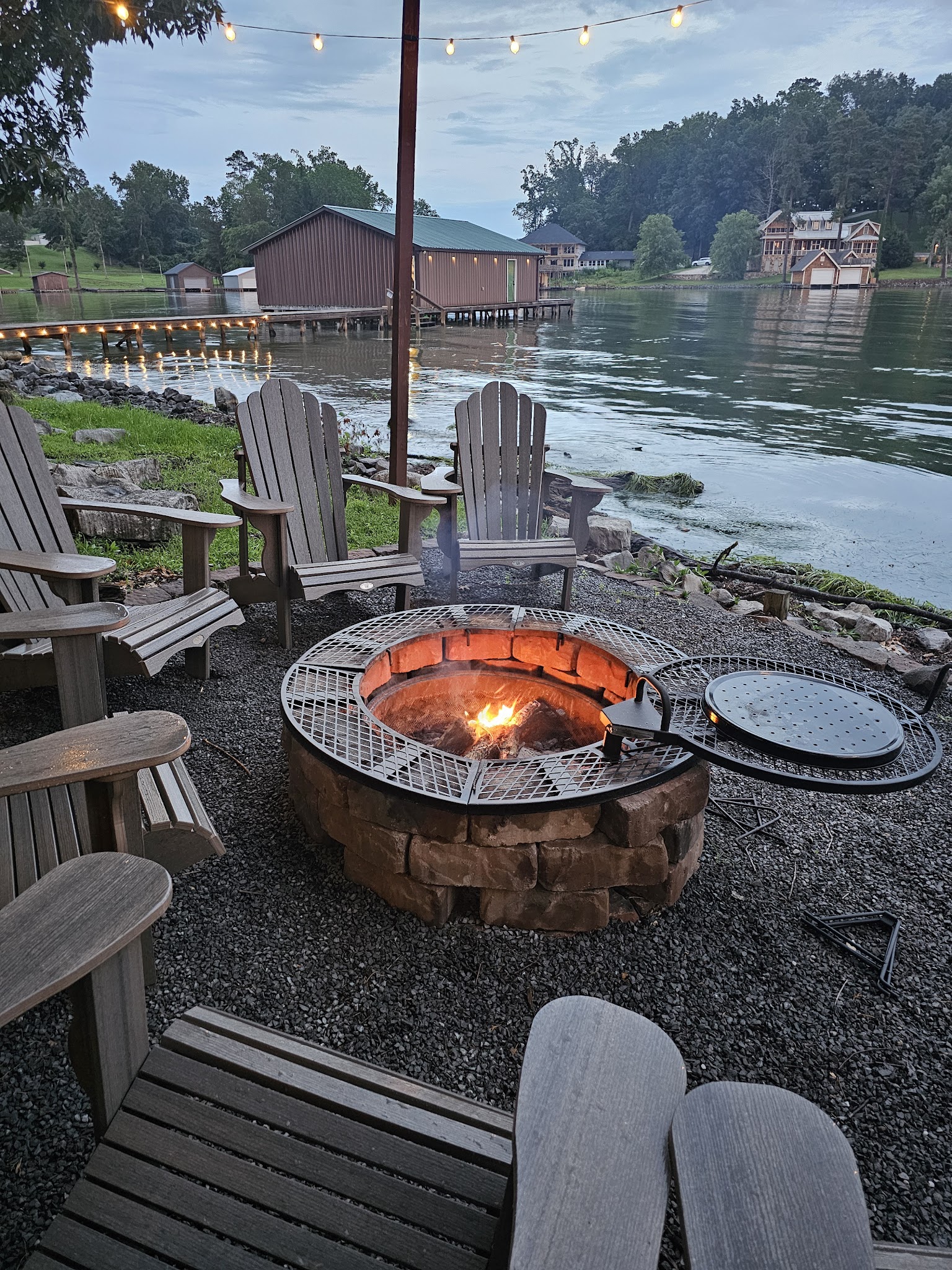 Fire pit and Adirondack chairs overlooking Lake Guntersville for small group retreat evenings